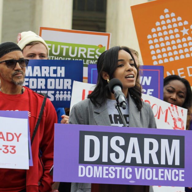 Legal Associate Makennan McBryde speaks at rally outside the US Supreme Court on the Rahimi case.