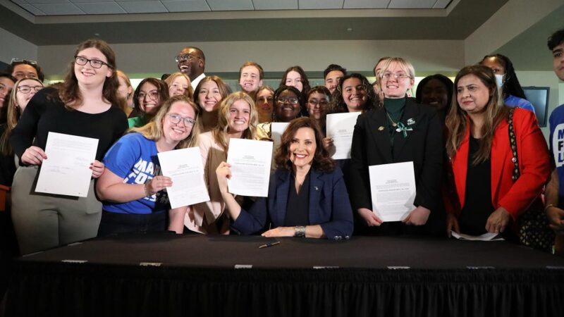 March For Our Lives activists gather around Gov. Whitmer as she signs historic gun safety into law.
