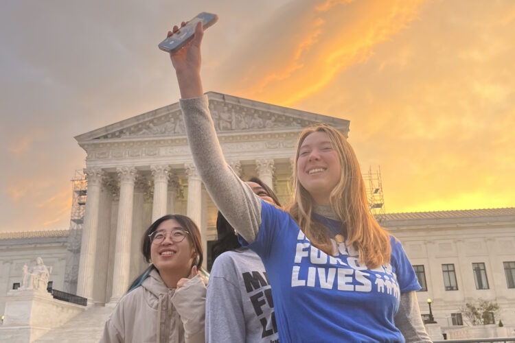 Yvin Shin, Makennan McBryde, and Brynn Jones pose for a selfie in front of the US Supreme Court.